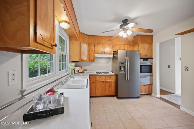 3 Mcelwaine Dr, Freehold, NJ 07728 - kitchen with stainless steel appliances, a warming drawer, under cabinet range hood, brown cabinetry, and ceiling fan