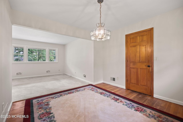 3 Mcelwaine Dr, Freehold, NJ 07728 - spare room with wood finished floors and a chandelier