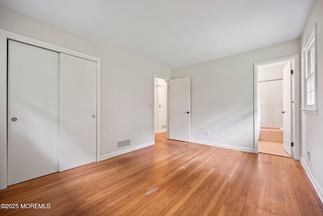 3 Mcelwaine Dr, Freehold, NJ 07728 - unfurnished bedroom with light wood-style flooring, a closet, and ensuite bath