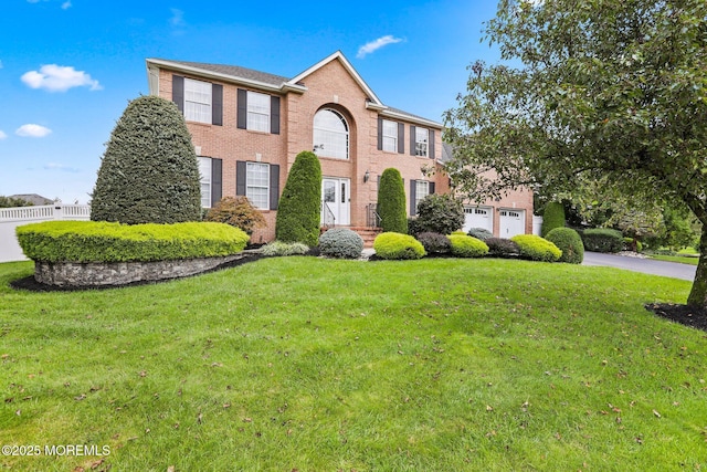 43 Shawnee Way, Morganville, NJ 07751 - colonial home with brick siding, asphalt driveway, and an attached garage
