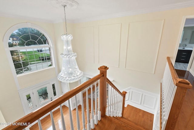 43 Shawnee Way, Morganville, NJ 07751 - stairway featuring crown molding, a chandelier, and wood finished floors