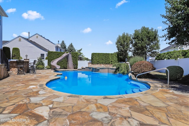 43 Shawnee Way, Morganville, NJ 07751 - view of pool featuring a water slide, a patio area, a fenced backyard, and outdoor dining area
