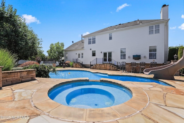 43 Shawnee Way, Morganville, NJ 07751 - view of pool featuring a water slide, a pool with connected hot tub, and a patio area