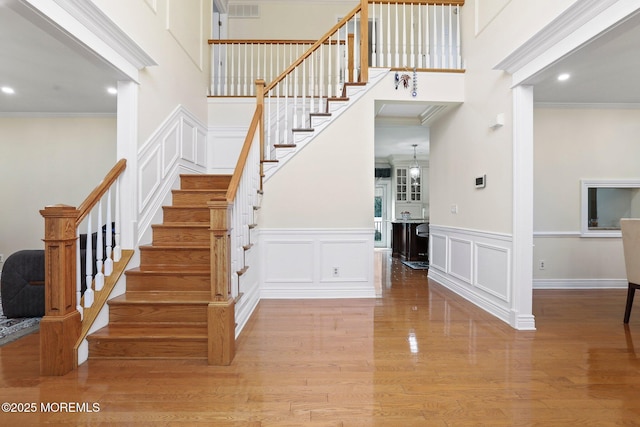 43 Shawnee Way, Morganville, NJ 07751 - stairs featuring ornamental molding, a decorative wall, wood finished floors, recessed lighting, and wainscoting
