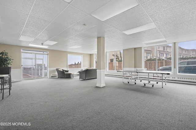 675 Ocean Ave # 9F, Long Branch, NJ 07740 - interior space featuring a drop ceiling, carpet, a wainscoted wall, and a baseboard heating unit