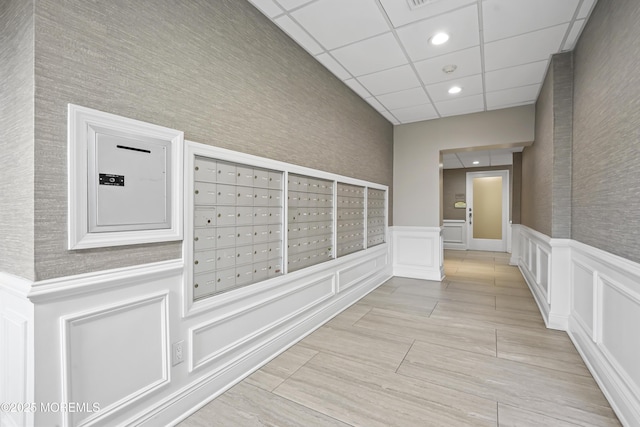 675 Ocean Ave # 9F, Long Branch, NJ 07740 - view of property's community featuring mail area, a decorative wall, a wainscoted wall, and recessed lighting