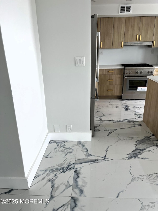 675 Ocean Ave # 9F, Long Branch, NJ 07740 - kitchen with appliances with stainless steel finishes, under cabinet range hood, and light marble finish flooring