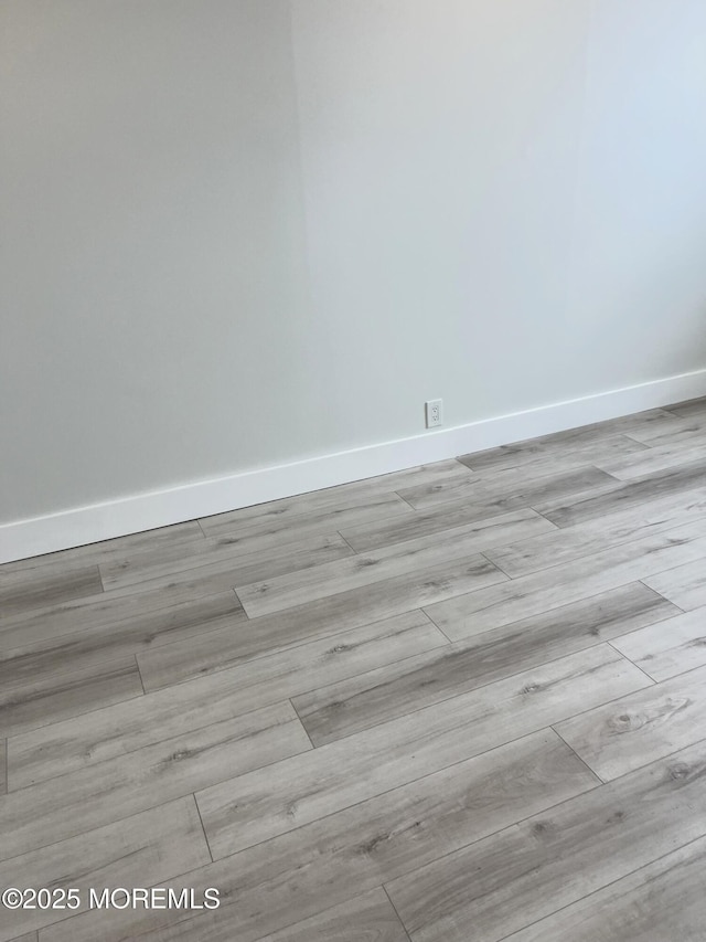 675 Ocean Ave # 9F, Long Branch, NJ 07740 - empty room with baseboards and wood finished floors