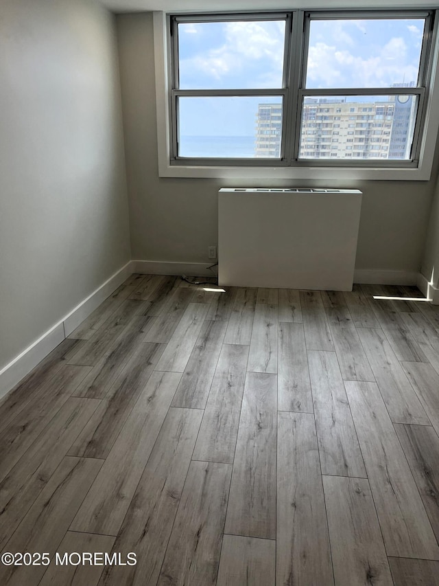 675 Ocean Ave # 9F, Long Branch, NJ 07740 - spare room featuring radiator and wood finished floors