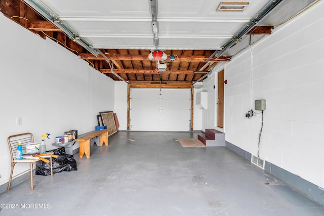 30 N Maplewood Dr, Brick, NJ 08723 - garage featuring a garage door opener and concrete block wall