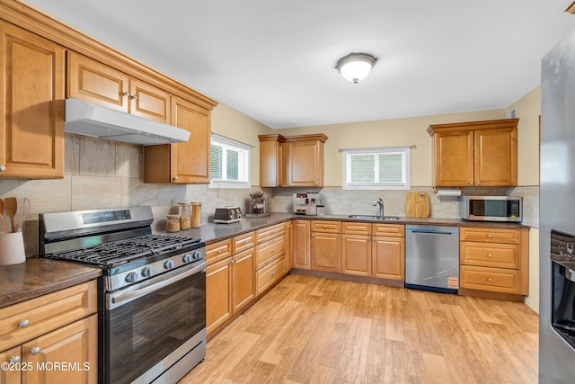30 N Maplewood Dr, Brick, NJ 08723 - kitchen with appliances with stainless steel finishes, under cabinet range hood, light wood finished floors, and backsplash