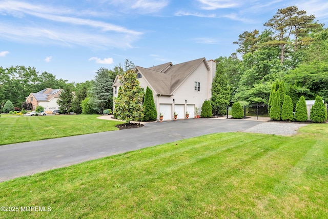 15 Conor Rd, Jackson, NJ 08527 - view of home's exterior with a garage, driveway, a chimney, a yard, and view of scattered trees
