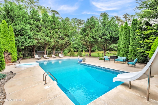 15 Conor Rd, Jackson, NJ 08527 - view of swimming pool featuring a water slide, a patio area, an outdoor hangout area, and view of wooded area