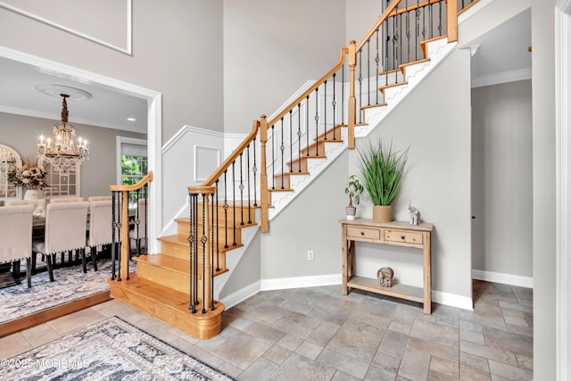15 Conor Rd, Jackson, NJ 08527 - stairs with a chandelier, crown molding, stone tile flooring, and a high ceiling