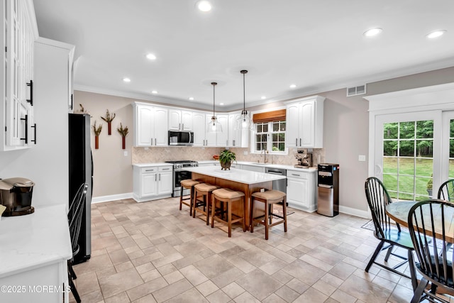 15 Conor Rd, Jackson, NJ 08527 - kitchen with appliances with stainless steel finishes, a breakfast bar area, tasteful backsplash, white cabinets, and light countertops