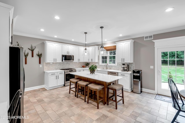 15 Conor Rd, Jackson, NJ 08527 - kitchen featuring appliances with stainless steel finishes, a breakfast bar area, backsplash, light countertops, and recessed lighting