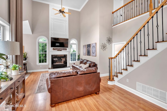 15 Conor Rd, Jackson, NJ 08527 - living room with a high ceiling, wood finished floors, ceiling fan, a glass covered fireplace, and stairs