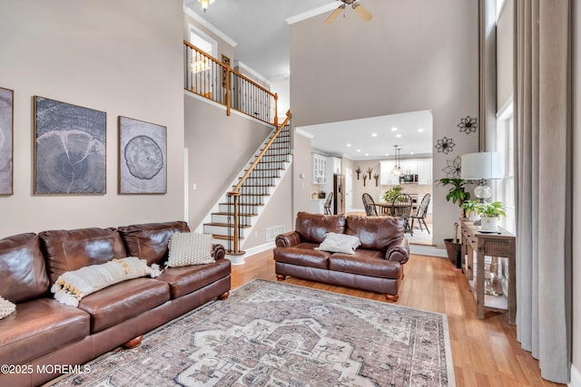 15 Conor Rd, Jackson, NJ 08527 - living area featuring a towering ceiling, stairs, light wood-style flooring, crown molding, and a ceiling fan