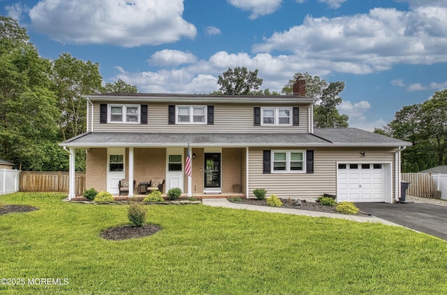 15 Liverpool Ct, Toms River, NJ 08753 - view of front of property featuring driveway, a chimney, a garage, a porch, and brick siding