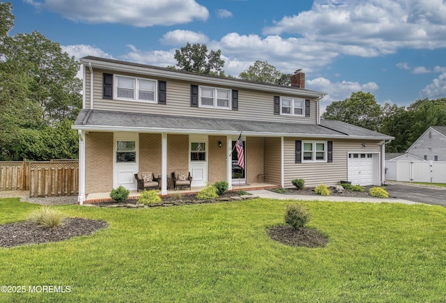 15 Liverpool Ct, Toms River, NJ 08753 - view of front facade featuring an attached garage, a chimney, covered porch, and asphalt driveway