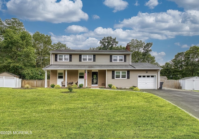 15 Liverpool Ct, Toms River, NJ 08753 - view of front of house with driveway, an attached garage, covered porch, and a chimney