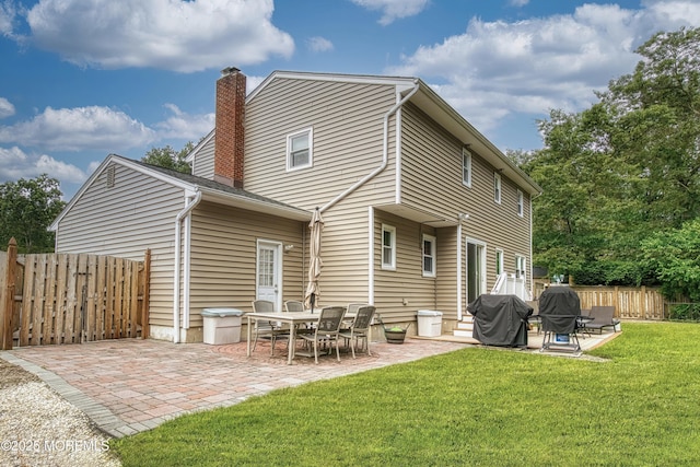 15 Liverpool Ct, Toms River, NJ 08753 - rear view of property featuring a patio and a chimney