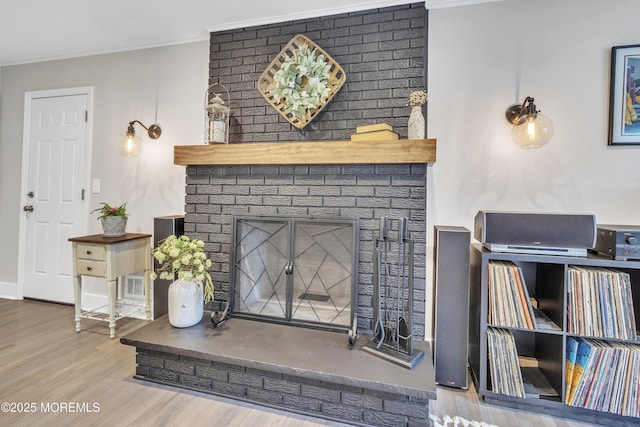 15 Liverpool Ct, Toms River, NJ 08753 - living area featuring wood finished floors, crown molding, and a brick fireplace