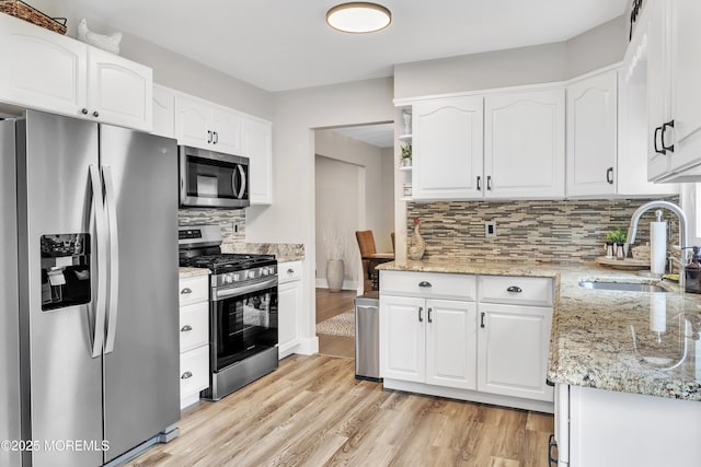 15 Liverpool Ct, Toms River, NJ 08753 - kitchen featuring appliances with stainless steel finishes, light wood-style floors, tasteful backsplash, and white cabinets