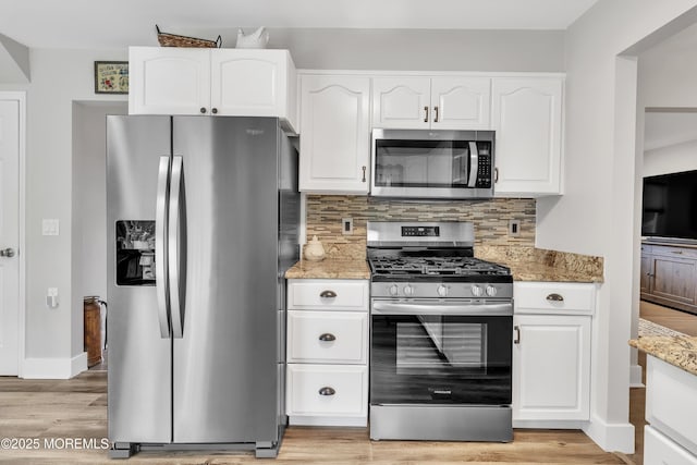 15 Liverpool Ct, Toms River, NJ 08753 - kitchen featuring stainless steel appliances, white cabinets, light stone counters, decorative backsplash, and light wood finished floors