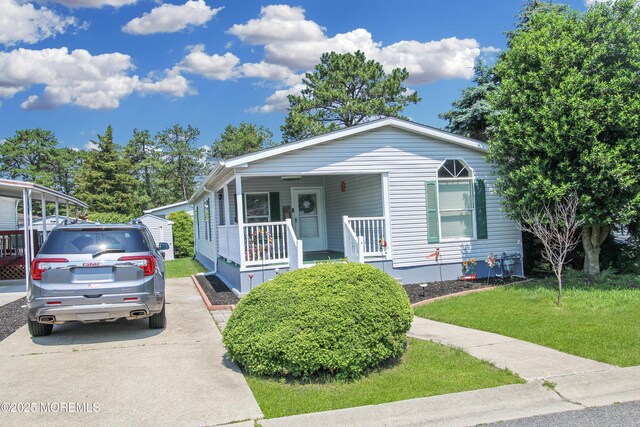 26 Pine Ridge Blvd, Whiting, NJ 08759 - view of front of home with a porch, a front lawn, and driveway