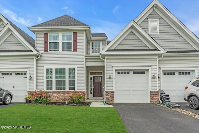 73 Aqueduct Blvd, New Egypt, NJ 08533 - view of front facade with stone siding, asphalt driveway, a front lawn, a garage, and a shingled roof