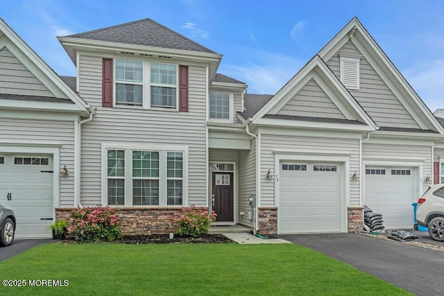 73 Aqueduct Blvd, New Egypt, NJ 08533 - view of front of house with stone siding, a front yard, driveway, and an attached garage