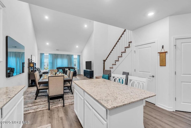 73 Aqueduct Blvd, New Egypt, NJ 08533 - kitchen featuring light wood-style floors, a kitchen island, recessed lighting, light stone counters, and high vaulted ceiling