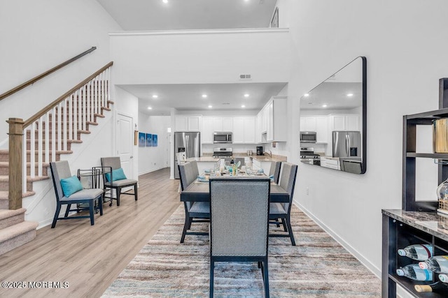 73 Aqueduct Blvd, New Egypt, NJ 08533 - dining area featuring stairs, light wood-type flooring, recessed lighting, and a towering ceiling