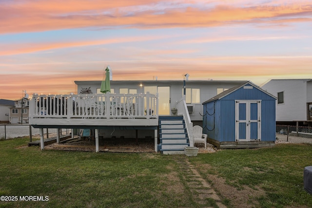 398 Kingfisher Rd, Tuckerton, NJ 08087 - back of property at dusk featuring a storage unit, a wooden deck, and stairway