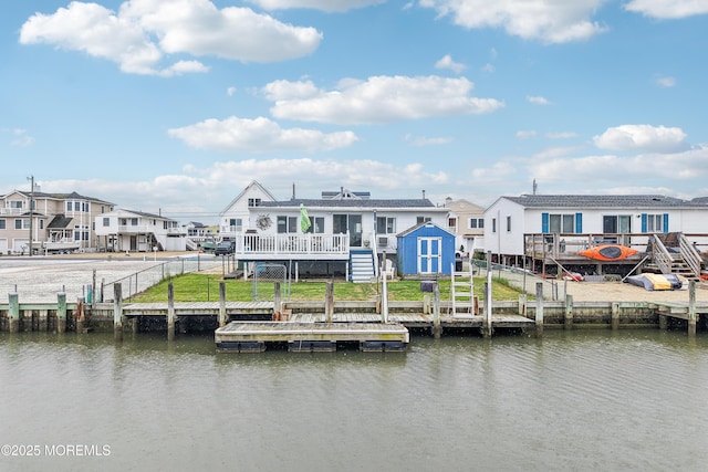 398 Kingfisher Rd, Tuckerton, NJ 08087 - back of property featuring a deck with water view, stairs, and a storage unit