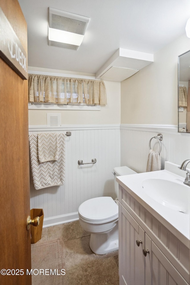 124 Mckinnon St, Piscataway Twp, NJ 08854 - half bathroom with vanity, wainscoting, and tile patterned floors