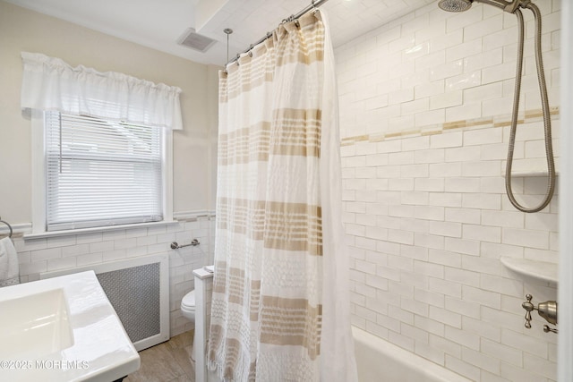 124 Mckinnon St, Piscataway Twp, NJ 08854 - bathroom featuring shower / tub combo, tile walls, vanity, radiator, and wainscoting