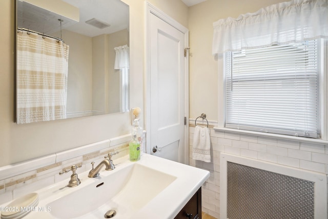 124 Mckinnon St, Piscataway Twp, NJ 08854 - full bathroom featuring tile walls, vanity, radiator, wainscoting, and a shower with curtain
