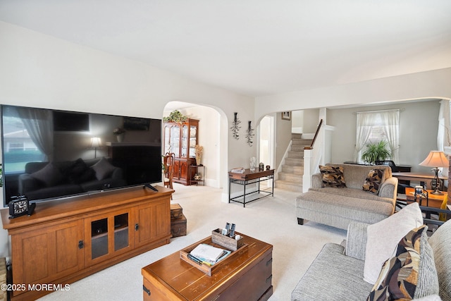 124 Mckinnon St, Piscataway Twp, NJ 08854 - living room with arched walkways, light carpet, and stairs