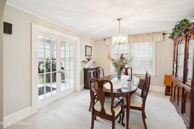 124 Mckinnon St, Piscataway Twp, NJ 08854 - dining area with a chandelier, light carpet, and crown molding