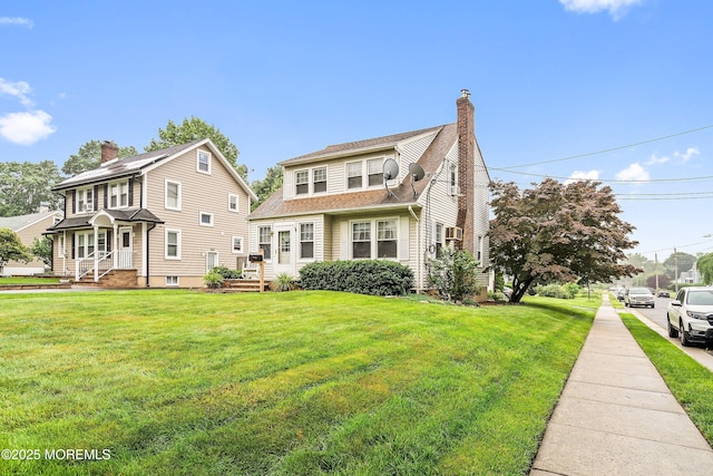124 Mckinnon St, Piscataway Twp, NJ 08854 - view of front of home with a front lawn, a chimney, and roof with shingles