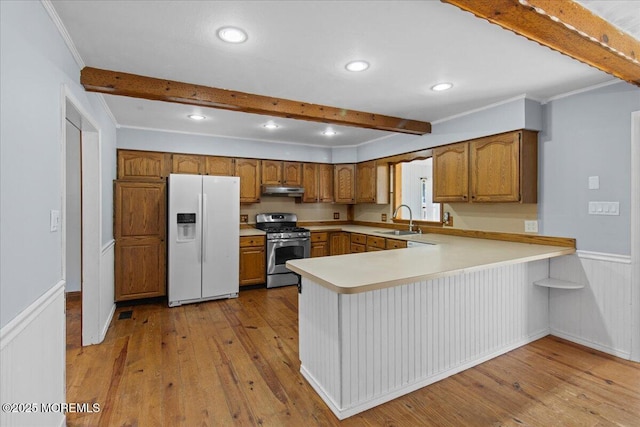 367 Marine St, Tuckerton, NJ 08087 - kitchen with white fridge with ice dispenser, stainless steel gas stove, beam ceiling, brown cabinets, and a peninsula