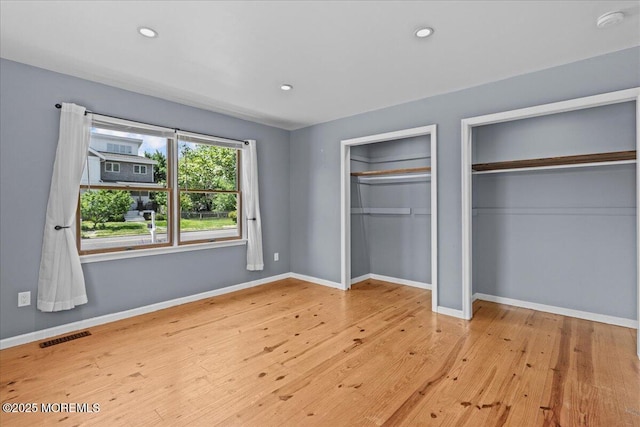 367 Marine St, Tuckerton, NJ 08087 - unfurnished bedroom featuring two closets, wood finished floors, and recessed lighting