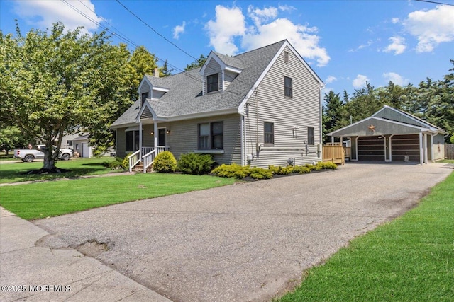 367 Marine St, Tuckerton, NJ 08087 - cape cod home with a front yard, a shingled roof, a detached carport, and an outbuilding