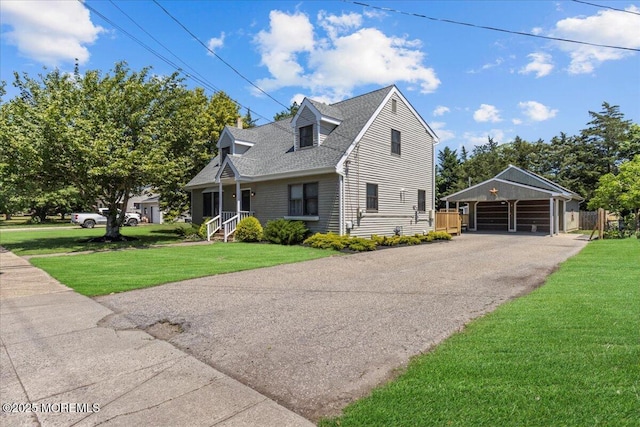 367 Marine St, Tuckerton, NJ 08087 - new england style home with a front yard, an outbuilding, a carport, and a shingled roof