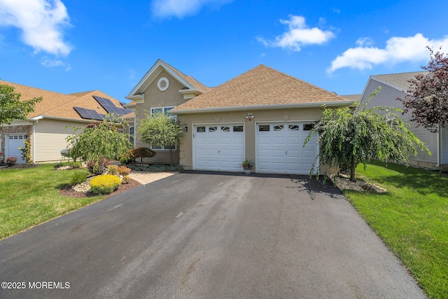130 Masters Dr, Monroe, NJ 08831 - view of front of house with an attached garage, asphalt driveway, a front yard, and stucco siding