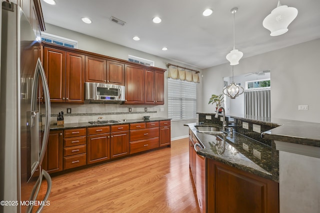 130 Masters Dr, Monroe, NJ 08831 - kitchen with appliances with stainless steel finishes, light wood finished floors, pendant lighting, recessed lighting, and backsplash