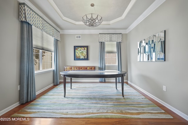 130 Masters Dr, Monroe, NJ 08831 - dining area featuring a raised ceiling, wood finished floors, ornamental molding, and a chandelier