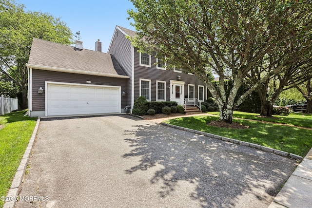404 5th Ave, Spring Lake, NJ 07762 - colonial-style house with driveway, a garage, a chimney, and a shingled roof